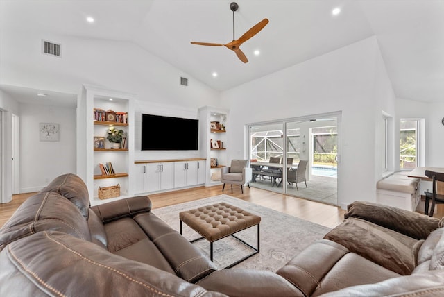 living area with visible vents, light wood finished floors, and ceiling fan