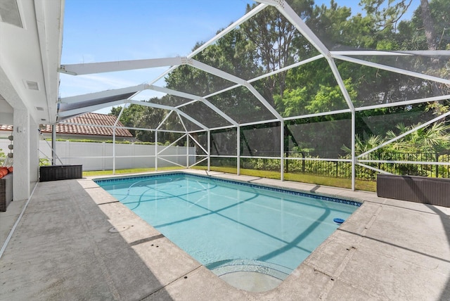 view of pool with a patio, a fenced backyard, glass enclosure, and a fenced in pool