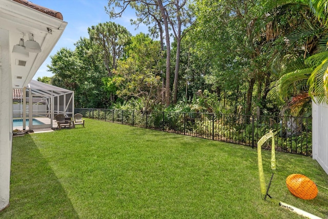 view of yard with a fenced backyard, a fenced in pool, and a lanai