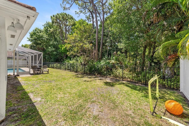 view of yard featuring a fenced in pool, a lanai, and a fenced backyard