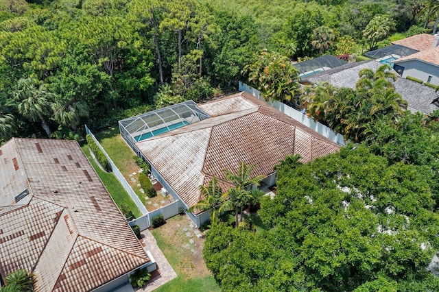 birds eye view of property featuring a view of trees