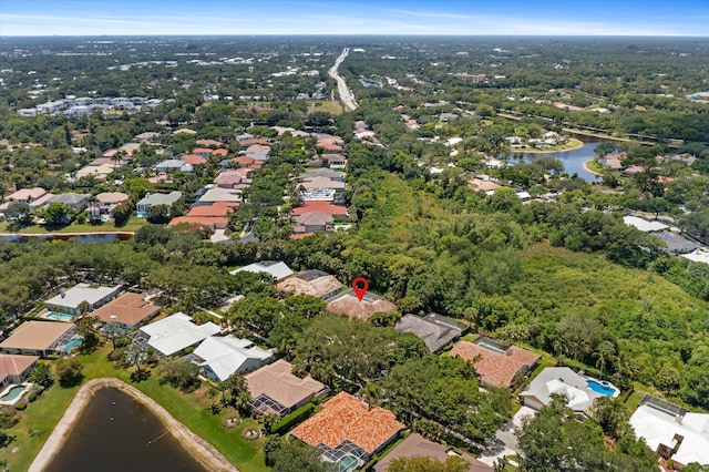birds eye view of property with a water view and a residential view