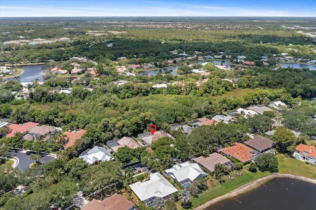 bird's eye view with a water view, a residential view, and a wooded view