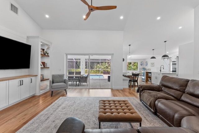living area featuring visible vents, high vaulted ceiling, recessed lighting, light wood-type flooring, and a ceiling fan