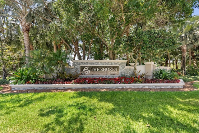 community / neighborhood sign with a lawn
