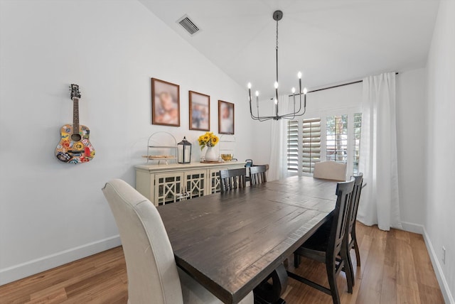 dining room with a chandelier, baseboards, visible vents, and light wood finished floors