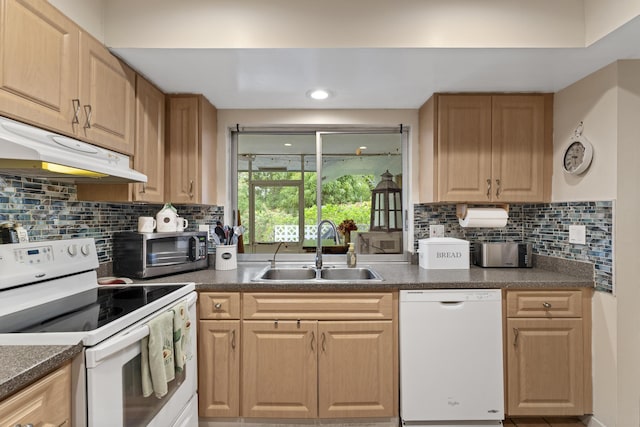 11711 Laurel Valley Cir, Wellington, FL 33414 - kitchen with a sink, white appliances, dark countertops, backsplash, and under cabinet range hood