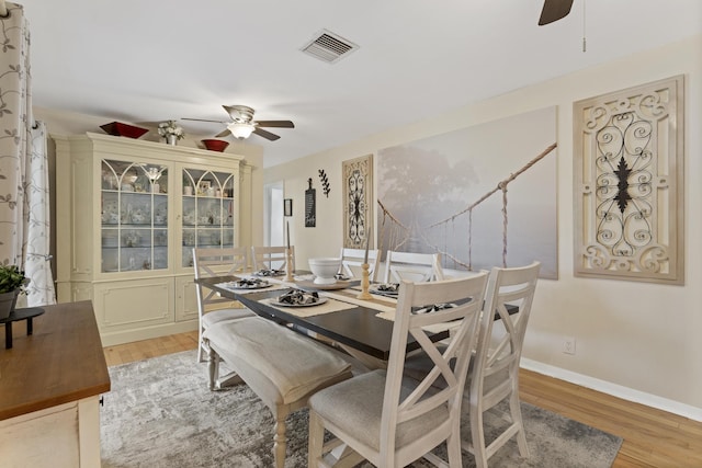 11711 Laurel Valley Cir, Wellington, FL 33414 - dining area featuring baseboards, a ceiling fan, visible vents, and light wood-style floors
