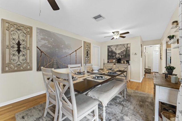 11711 Laurel Valley Cir, Wellington, FL 33414 - dining room with baseboards, visible vents, ceiling fan, and wood finished floors