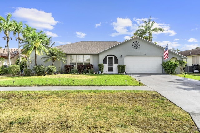 11711 Laurel Valley Cir, Wellington, FL 33414 - ranch-style home featuring concrete driveway, a front yard, stucco siding, and a garage