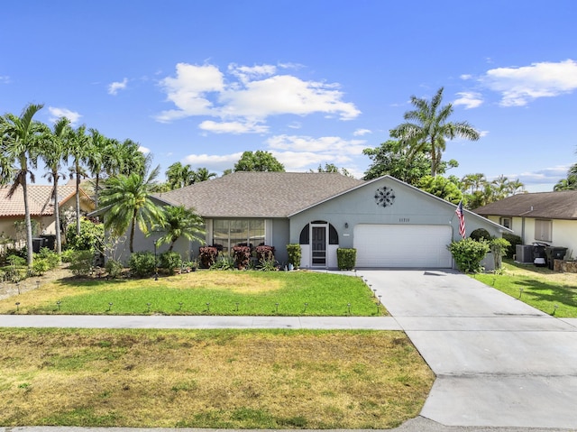 11711 Laurel Valley Cir, Wellington, FL 33414 - ranch-style home with concrete driveway, a front yard, central AC, and an attached garage
