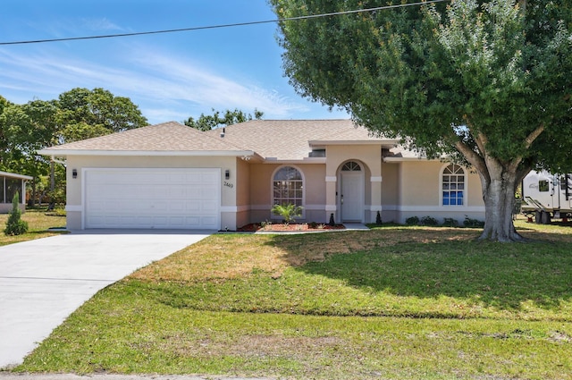 2449 SE Rock Springs Dr, Port Saint Lucie, FL 34952 - single story home with stucco siding, a garage, concrete driveway, and a front yard