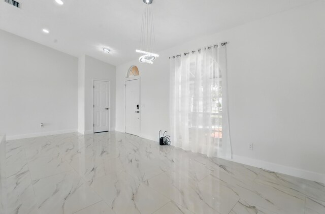 2449 SE Rock Springs Dr, Port Saint Lucie, FL 34952 - empty room with marble finish flooring, recessed lighting, and baseboards