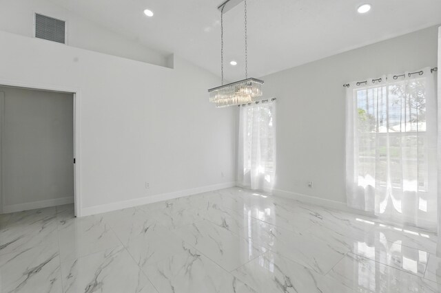 2449 SE Rock Springs Dr, Port Saint Lucie, FL 34952 - unfurnished room with recessed lighting, baseboards, lofted ceiling, a chandelier, and marble look tile flooring