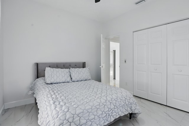 2449 SE Rock Springs Dr, Port Saint Lucie, FL 34952 - bedroom with light marble finish floors, a closet, and baseboards