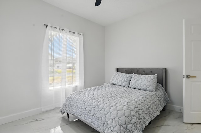 2449 SE Rock Springs Dr, Port Saint Lucie, FL 34952 - bedroom with light marble finish floors, multiple windows, baseboards, and ceiling fan