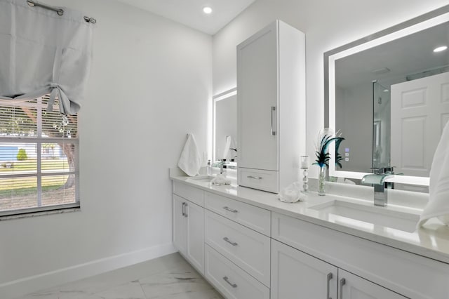 2449 SE Rock Springs Dr, Port Saint Lucie, FL 34952 - full bathroom featuring baseboards, a shower, double vanity, marble look tile flooring, and recessed lighting