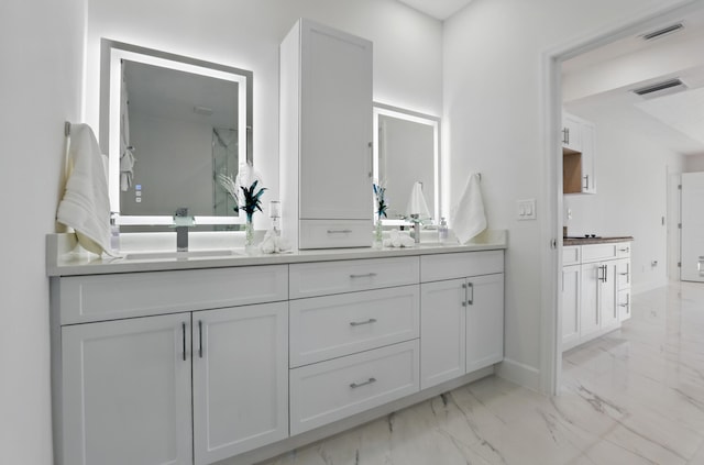 2449 SE Rock Springs Dr, Port Saint Lucie, FL 34952 - bathroom with marble look tiles, double vanity, and baseboards