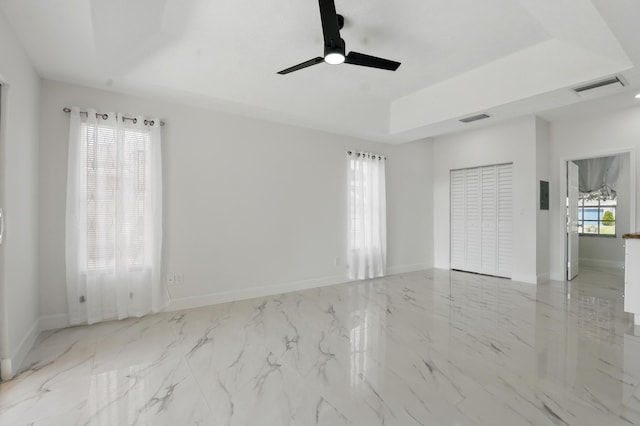 2449 SE Rock Springs Dr, Port Saint Lucie, FL 34952 - empty room with a raised ceiling, a ceiling fan, baseboards, and marble finish flooring