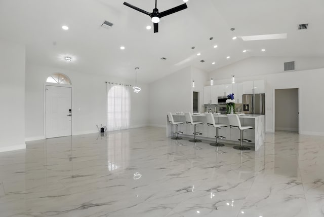 2449 SE Rock Springs Dr, Port Saint Lucie, FL 34952 - living room with light marble finish flooring, high vaulted ceiling, baseboards, recessed lighting, and a ceiling fan