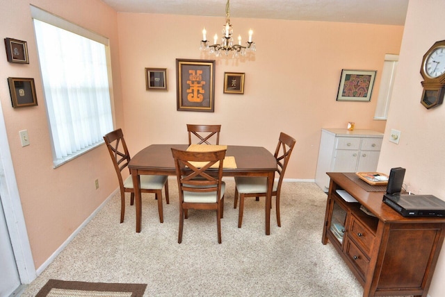 1225 NW 21st St Unit 2010, Stuart, FL 34994 - dining space with baseboards, light colored carpet, and a notable chandelier