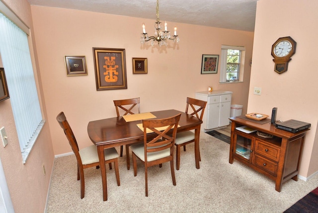 1225 NW 21st St Unit 2010, Stuart, FL 34994 - dining space featuring light colored carpet, baseboards, and a chandelier