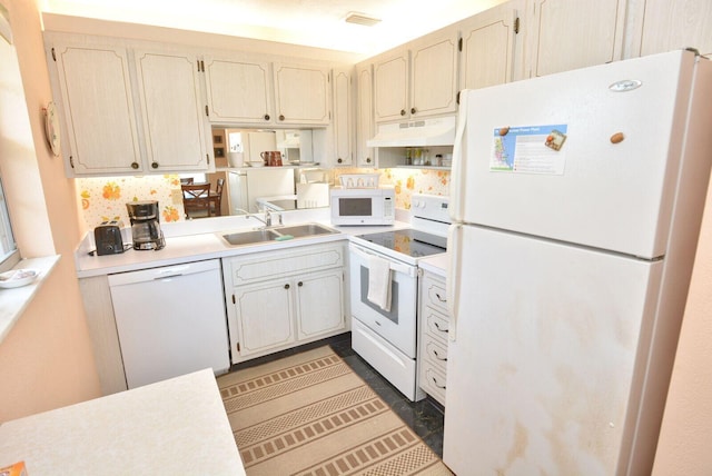 1225 NW 21st St Unit 2010, Stuart, FL 34994 - kitchen with a sink, under cabinet range hood, white appliances, and light countertops