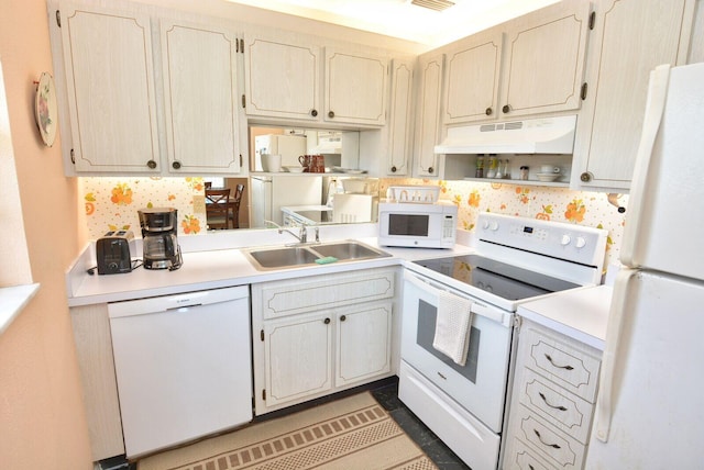 1225 NW 21st St Unit 2010, Stuart, FL 34994 - kitchen with visible vents, a sink, light countertops, under cabinet range hood, and white appliances