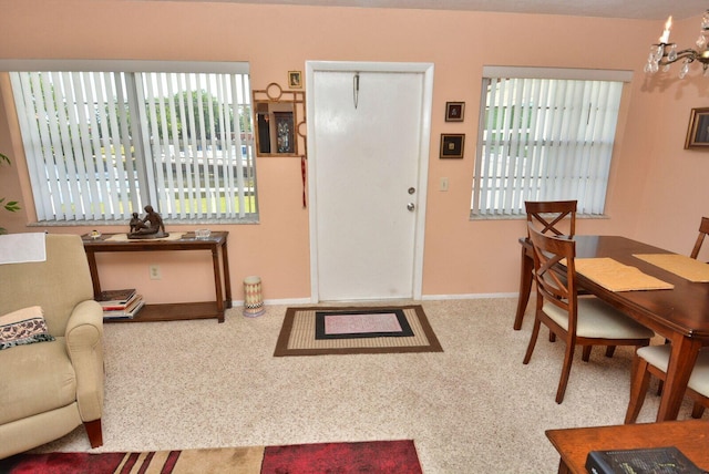 1225 NW 21st St Unit 2010, Stuart, FL 34994 - foyer entrance with carpet flooring, baseboards, and an inviting chandelier