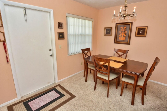 1225 NW 21st St Unit 2010, Stuart, FL 34994 - carpeted dining room with baseboards and an inviting chandelier