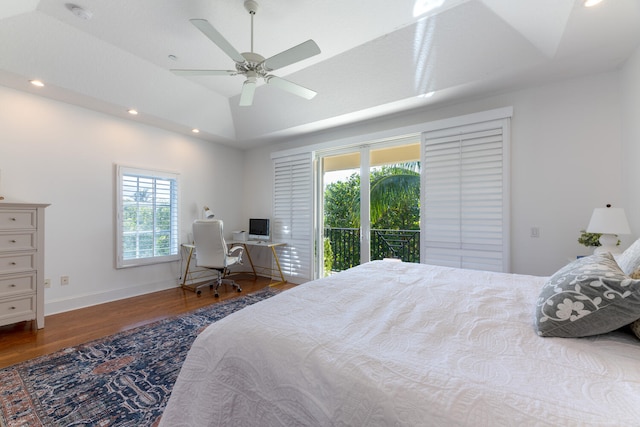 bedroom featuring lofted ceiling, wood finished floors, baseboards, access to outside, and recessed lighting