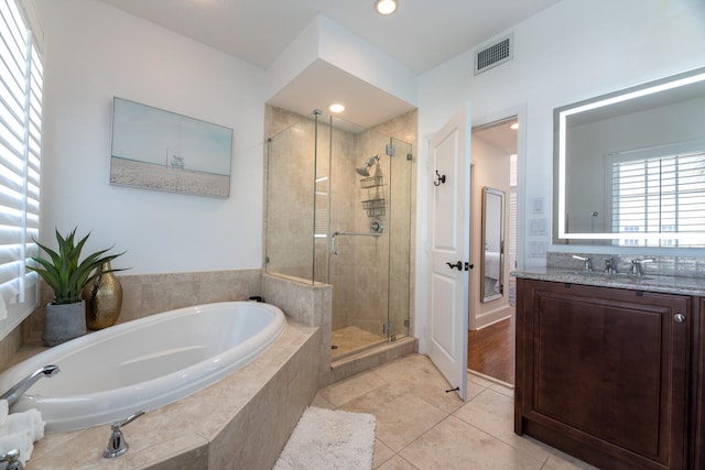 full bathroom with vanity, tile patterned floors, visible vents, a bath, and a stall shower