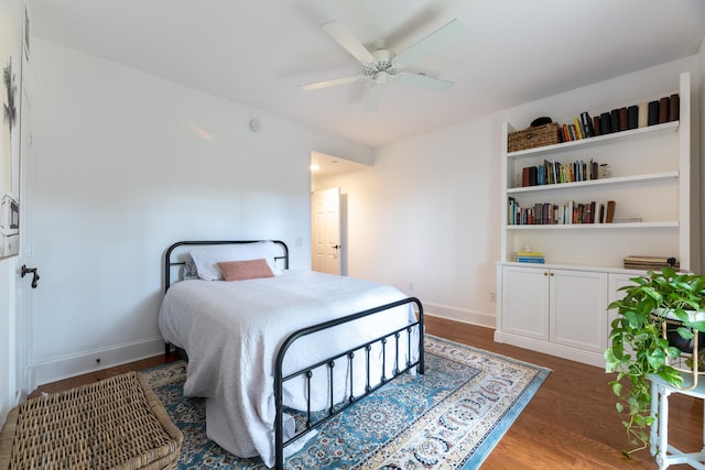 bedroom with baseboards, a ceiling fan, and wood finished floors