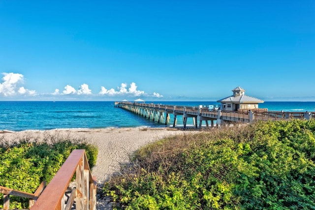 view of water feature featuring a pier and a view of the beach