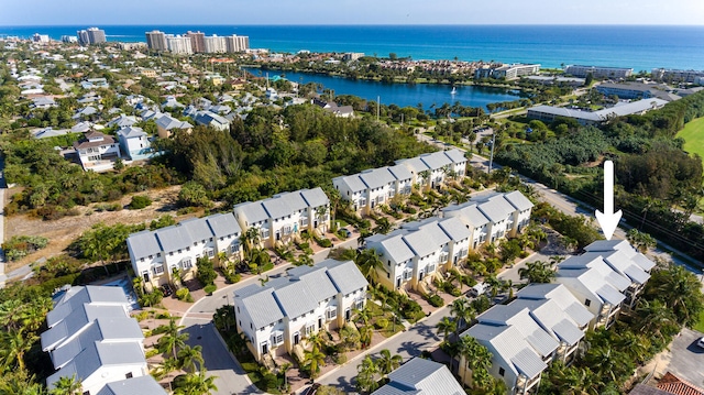 birds eye view of property with a water view and a residential view