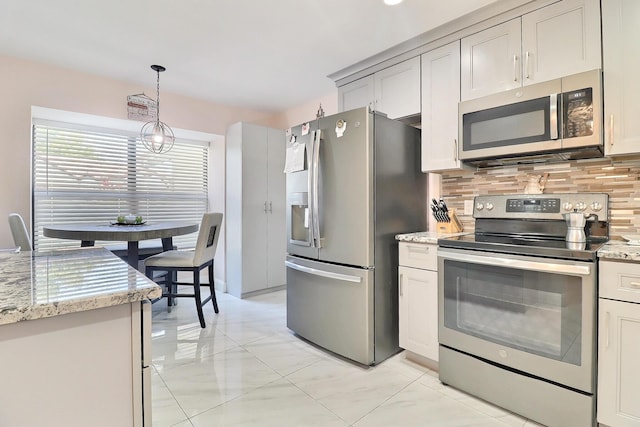 8216 Waterline Dr, Boynton Beach, FL 33472 - kitchen featuring backsplash, appliances with stainless steel finishes, hanging light fixtures, light stone countertops, and a notable chandelier