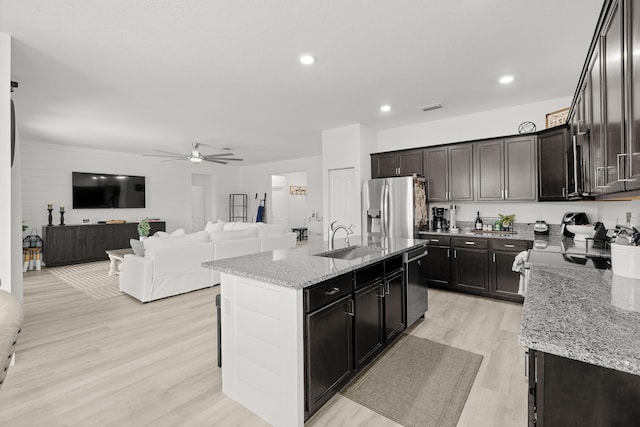 kitchen featuring ceiling fan, visible vents, appliances with stainless steel finishes, a sink, and light wood-style floors