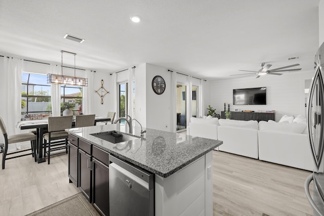 kitchen featuring appliances with stainless steel finishes, a sink, visible vents, and light wood-style floors