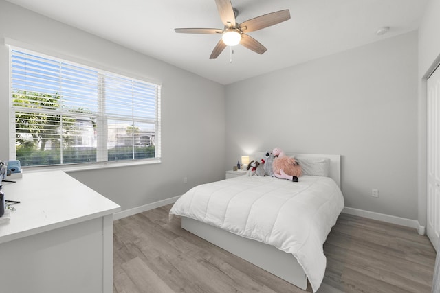 7509 NW Greenspring St, Port Saint Lucie, FL 34987 - bedroom with baseboards, light wood-style floors, and ceiling fan