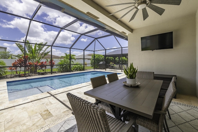view of swimming pool featuring ceiling fan, outdoor dining area, glass enclosure, a fenced in pool, and a patio