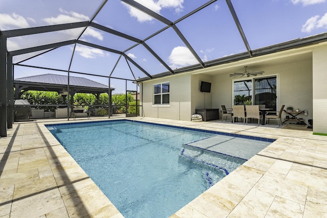 pool featuring outdoor dining area, a patio, ceiling fan, and glass enclosure