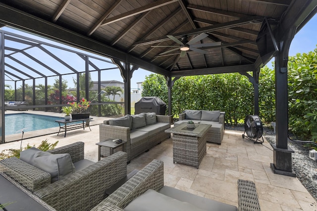 view of patio / terrace with a gazebo, an outdoor hangout area, ceiling fan, an outdoor pool, and glass enclosure