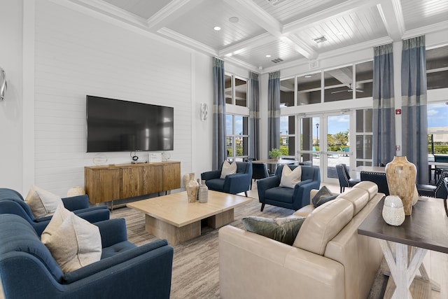 living area with french doors, ornamental molding, coffered ceiling, and beam ceiling