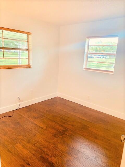 2821 Duke Ln, Delray Beach, FL 33445 - unfurnished room with baseboards and wood finished floors