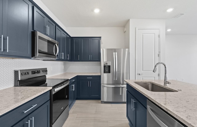 7646 SW Lucy Ln Unit 52-10, Stuart, FL 34997 - kitchen with appliances with stainless steel finishes, a sink, backsplash, light stone countertops, and recessed lighting