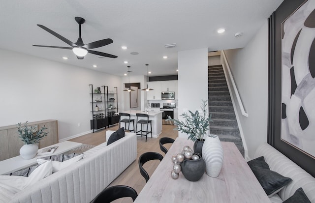 7636 SW Lucy Ln Unit Latitude 48-09, Stuart, FL 34997 - living room featuring light wood finished floors, stairs, ceiling fan, recessed lighting, and baseboards