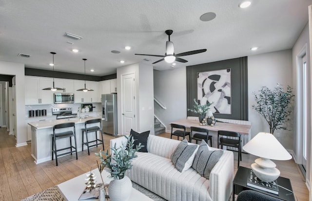 7636 SW Lucy Ln Unit Latitude 48-09, Stuart, FL 34997 - living area with stairway, light wood-style flooring, ceiling fan, recessed lighting, and baseboards