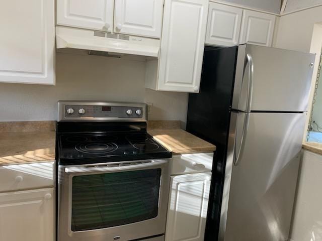 kitchen with light countertops, white cabinets, stainless steel appliances, and under cabinet range hood