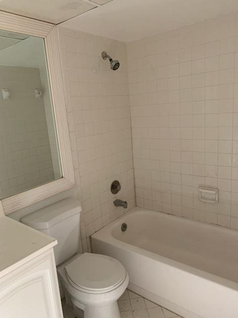 bathroom featuring toilet, tile patterned floors, shower / washtub combination, and vanity