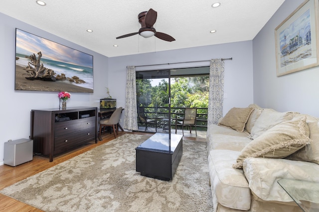 living room featuring recessed lighting, ceiling fan, wood finished floors, and a textured ceiling